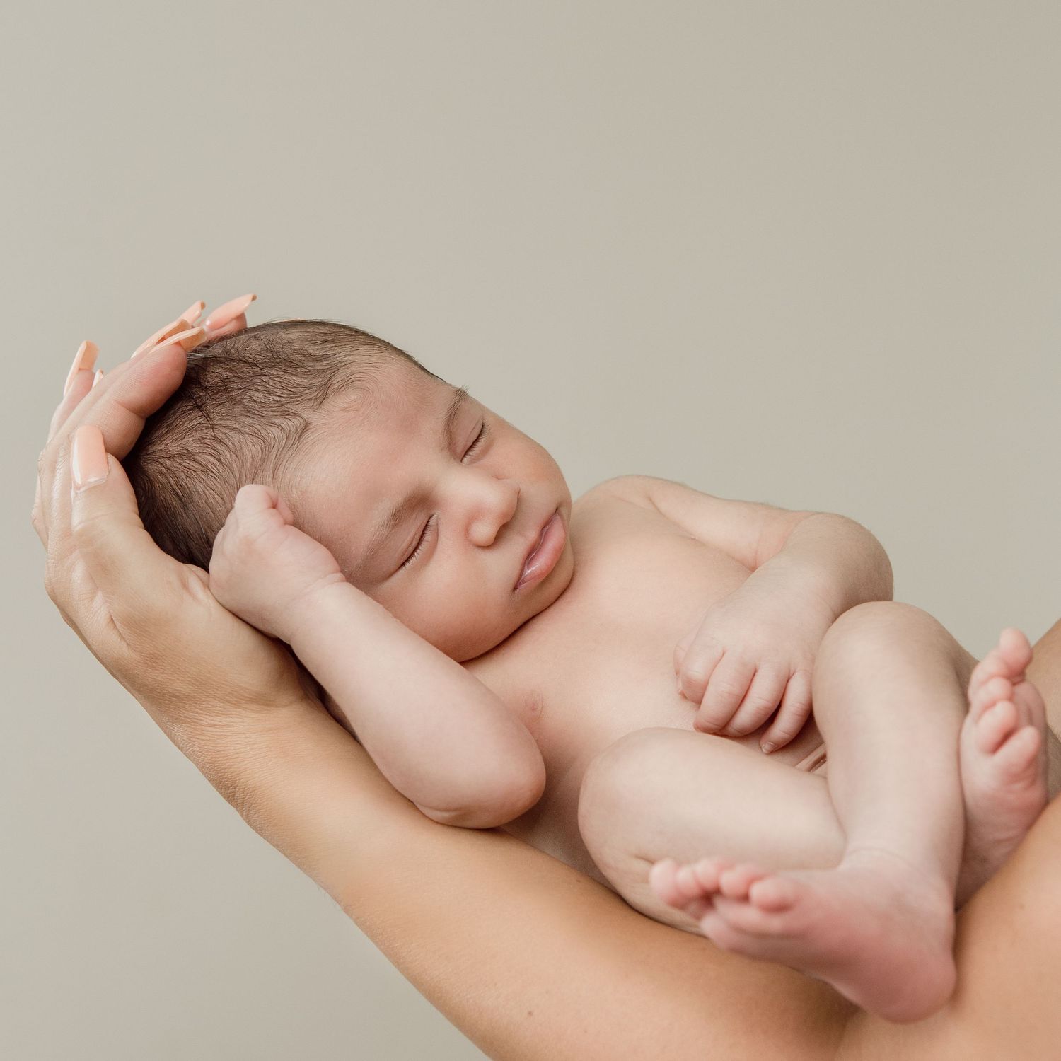 newborn photoshoot. mother holding baby boy.