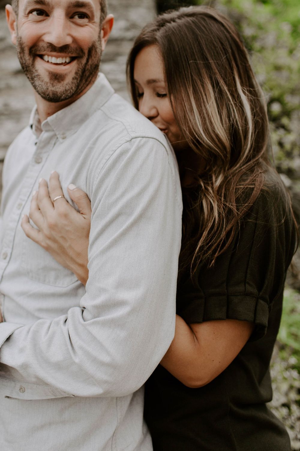 Intimate couple's photoshoot featuring tender moments against a natural backdrop.