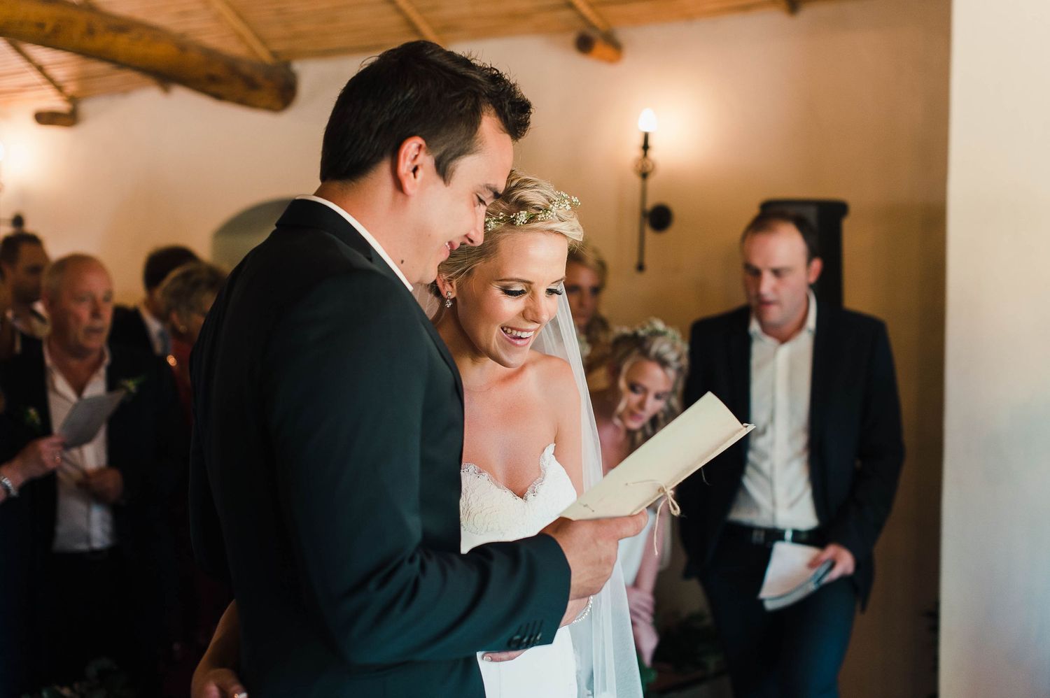 bride and groom following along with the words the hymn during their wedding ceremony