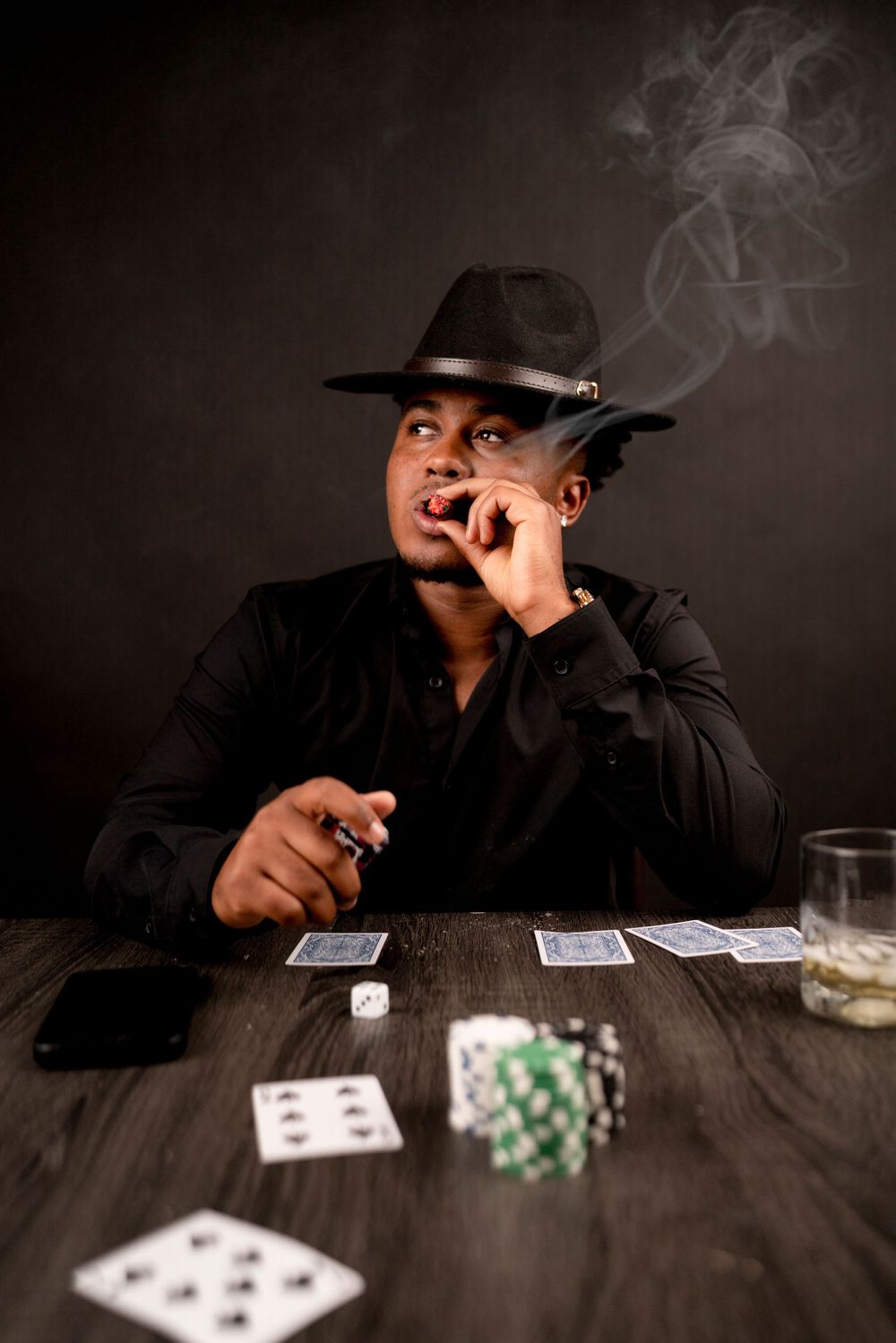 Casino themed portrait with playing cards and poker chips on dark wooden table.