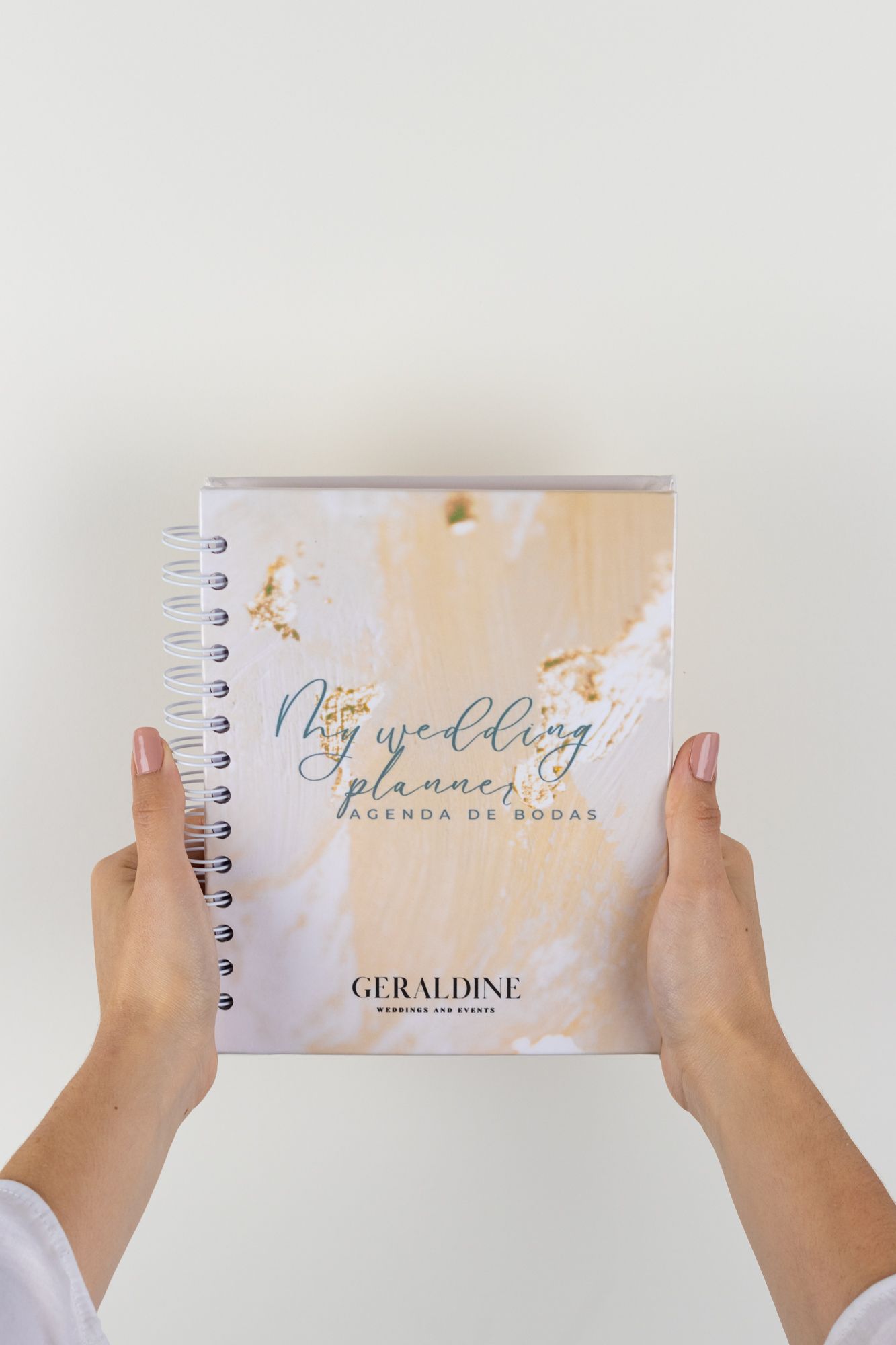 Elegant wedding planner notebooks with calligraphy text shown in a sequence of hands holding them.