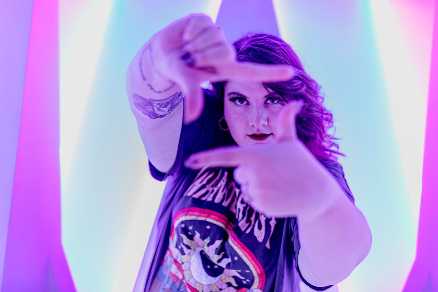 Dramatic portrait with purple neon lighting effects creating a retro aesthetic.