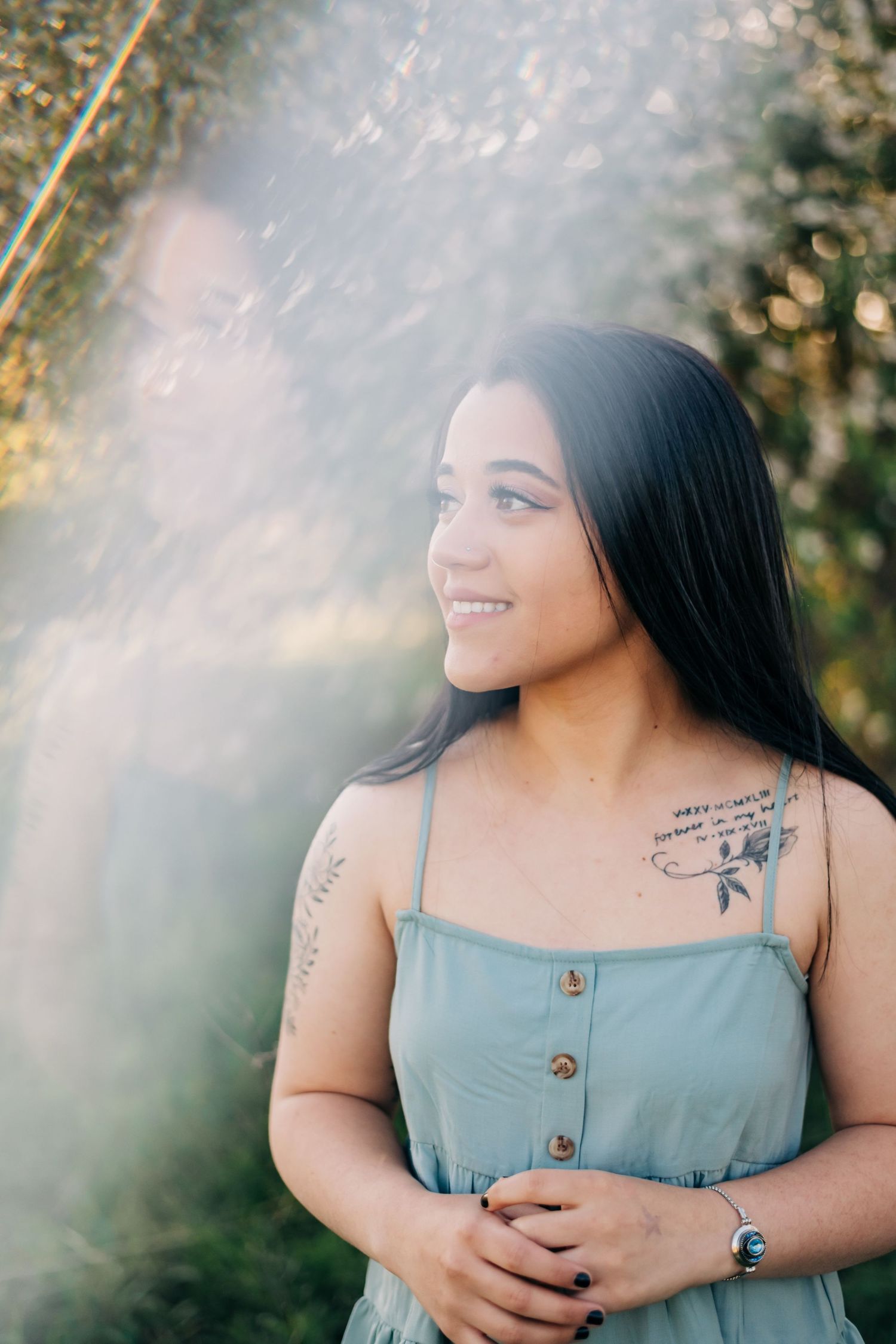 high school senior wearing a blue tank top looking off to her right