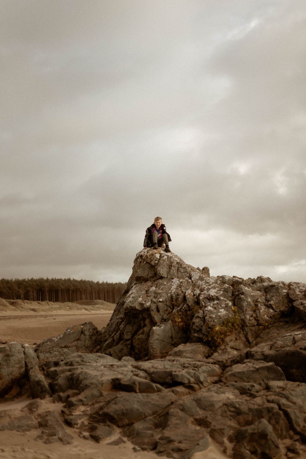 person sitting on rocks