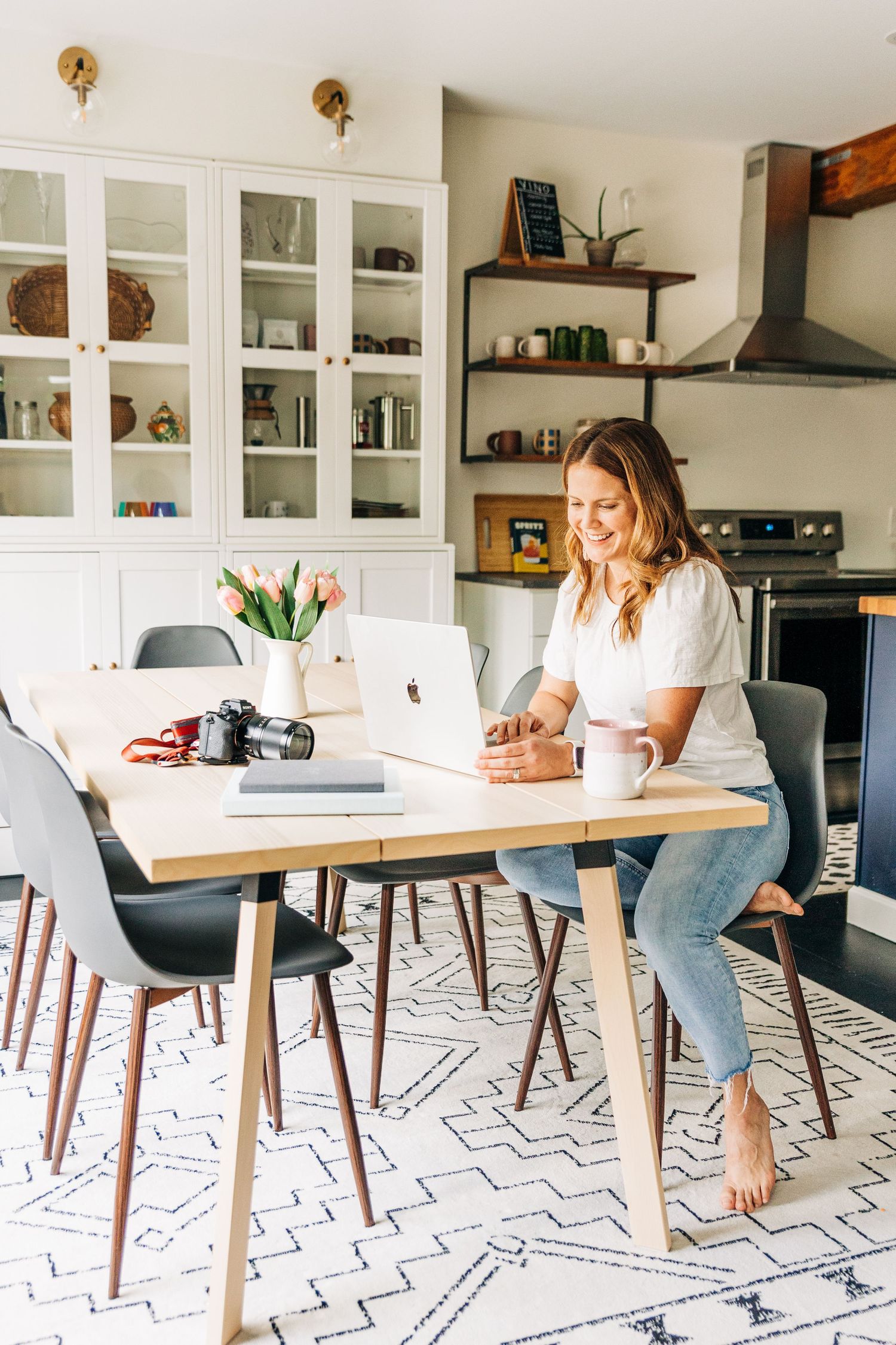 woman looking at her laptop at dining table at Little Villa Charlotte