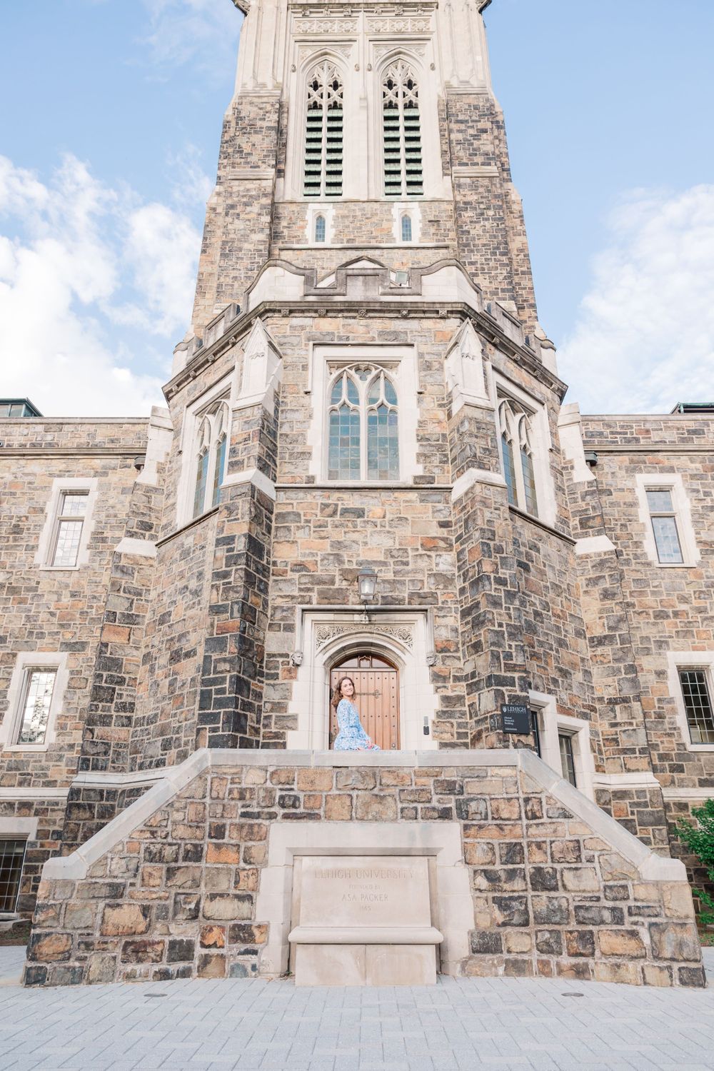 Gothic stone church exterior with ornate architecture and steps leading to wooden doors.