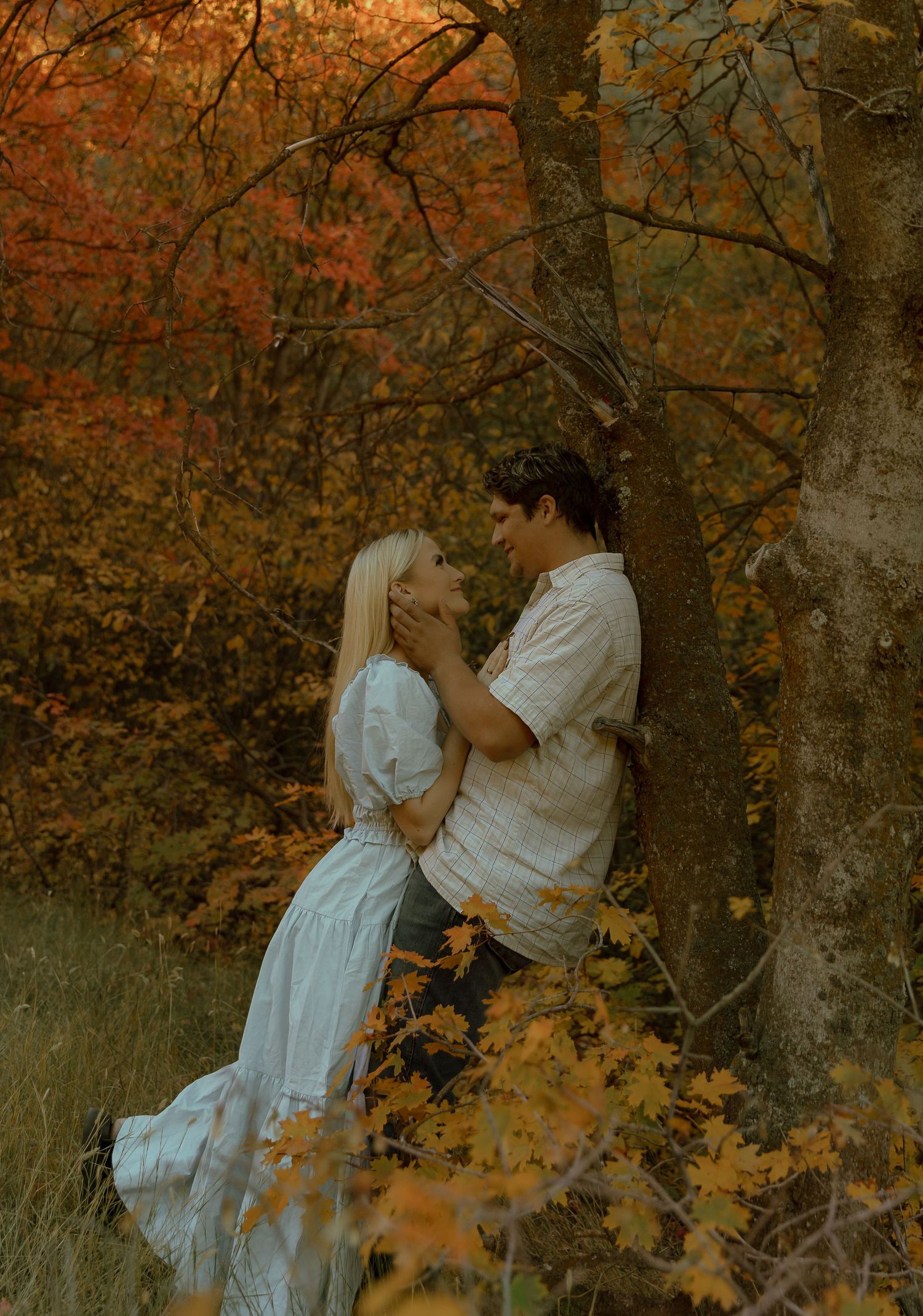 A couple looking into each other's eyes in fall at their engagements