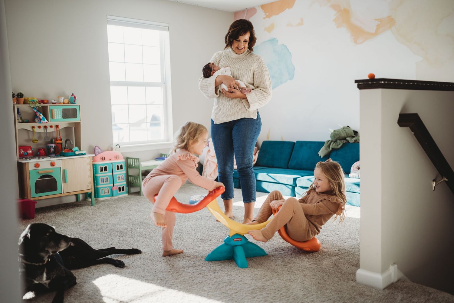 Active family playtime scene in bright playroom with world map wall decor.