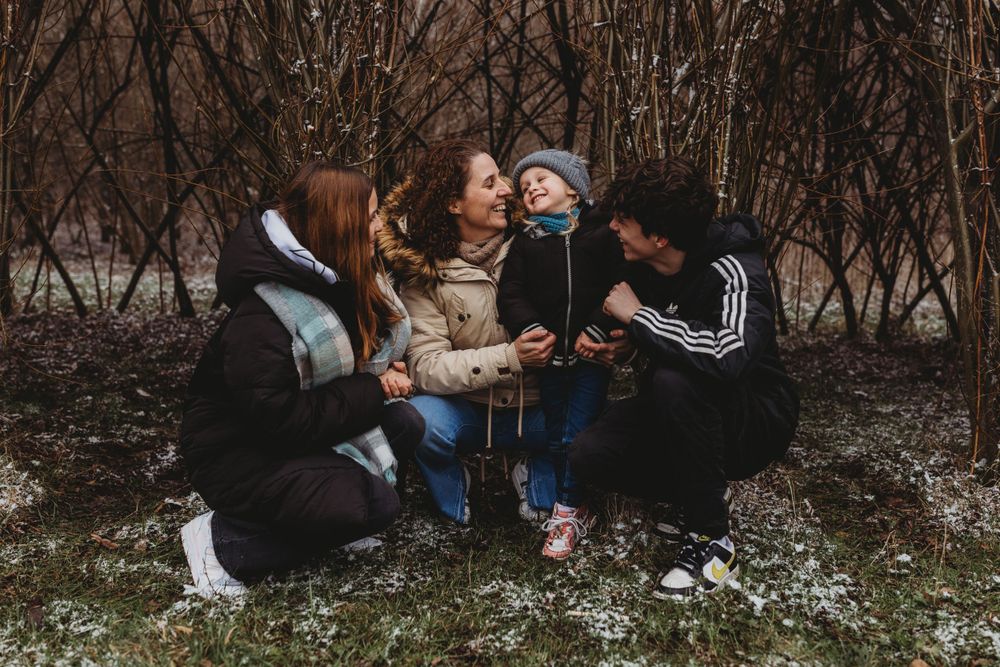 Group enjoying quality time together sitting outdoors in winter scenery.