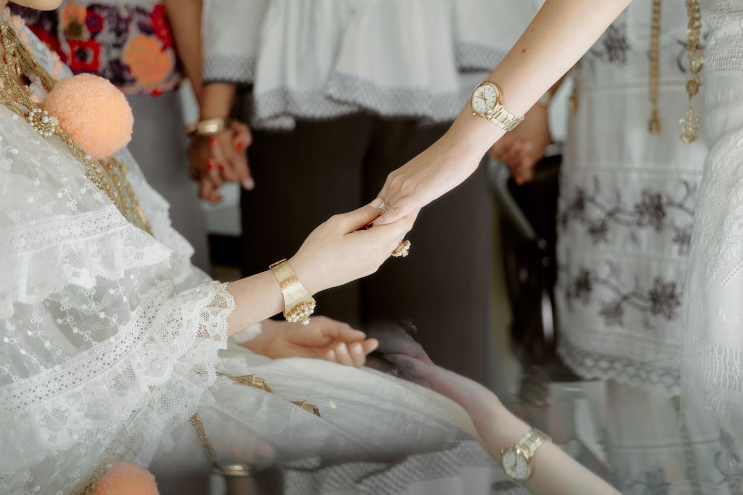Close-up of hands exchanging rings during traditional wedding ceremony.