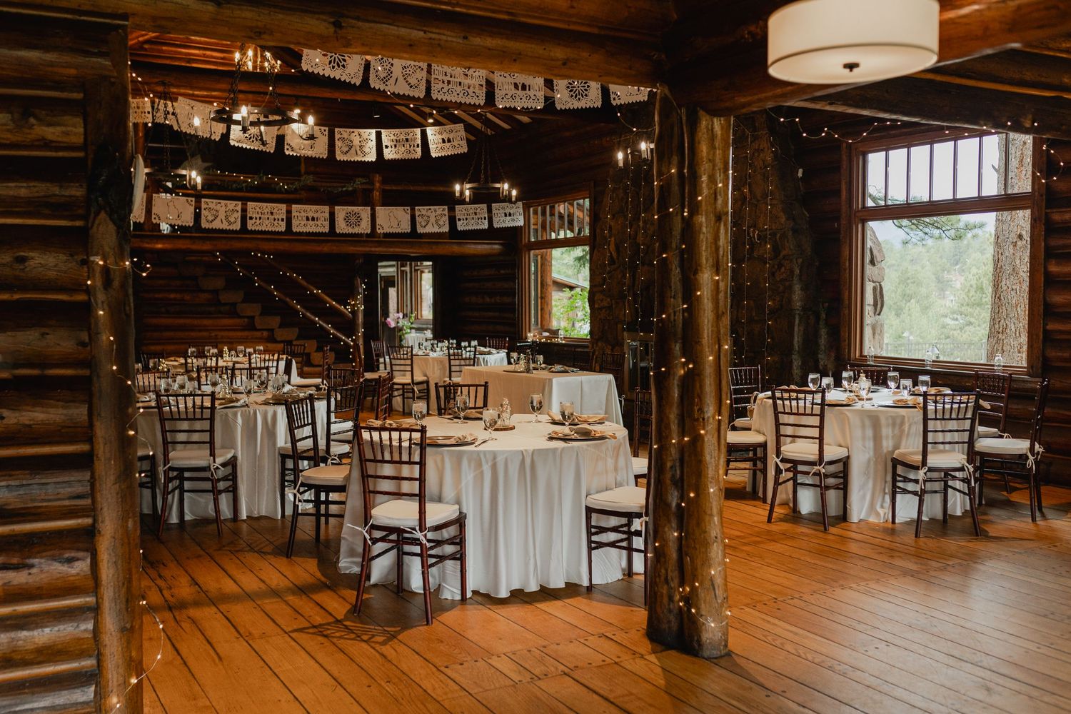 Wedding decor details, including elegant table settings with mountain views in the background.