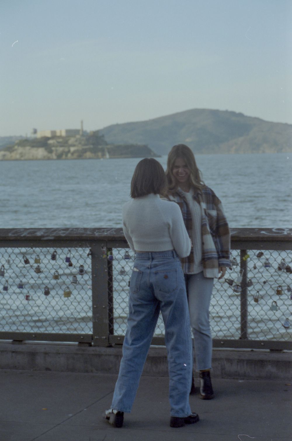 Casual meetup at San Francisco's waterfront with Alcatraz Island visible across the bay.
