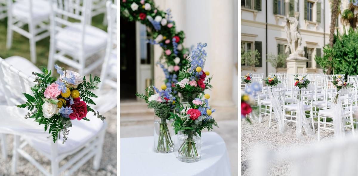 Three wedding ceremony settings with white chairs and colorful floral arrangements in glass vases.