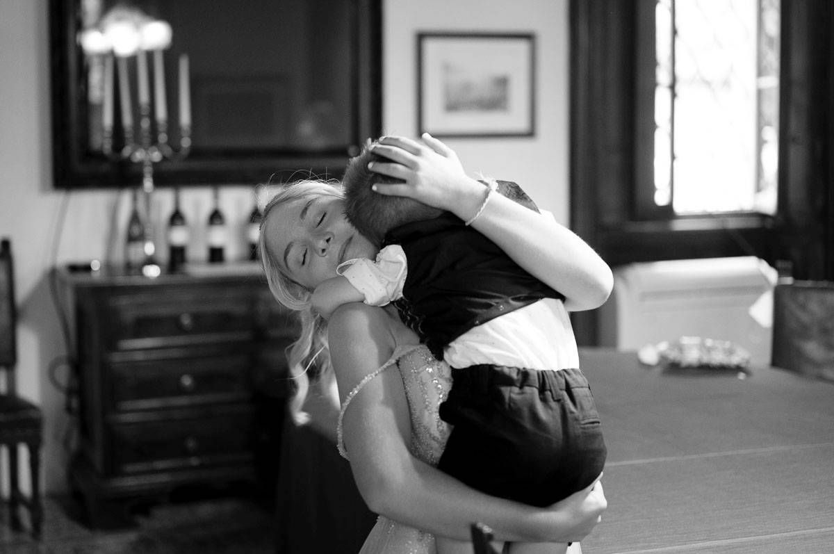 Black and white candid photo showing joyful dancing at a wedding celebration.