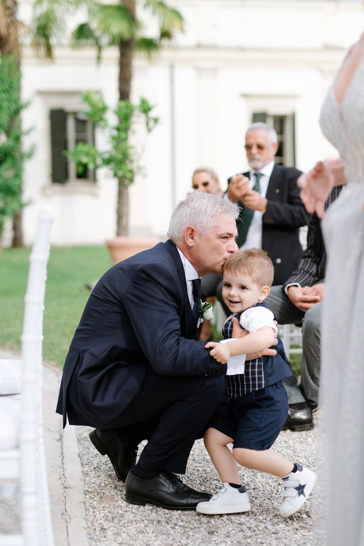 A tender moment captured between guests during an outdoor wedding celebration.