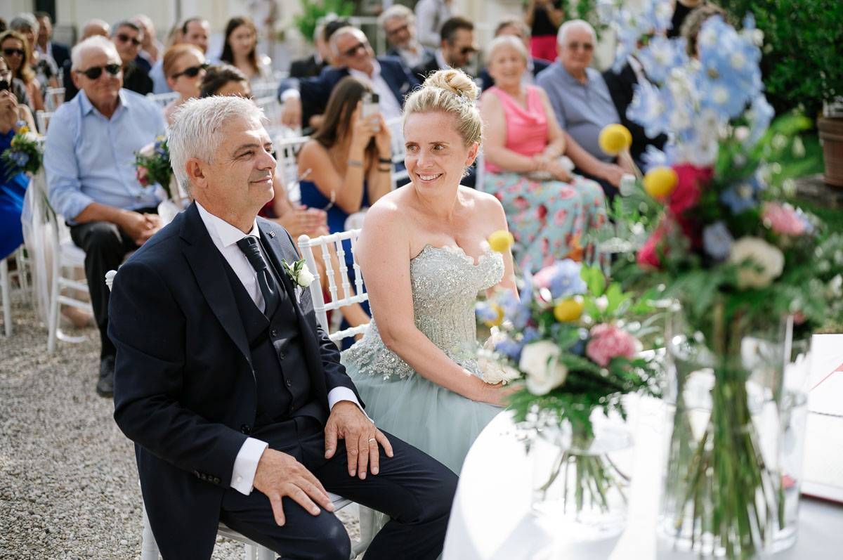 A wedding ceremony setup with beautiful floral arrangements and white chairs for guests.