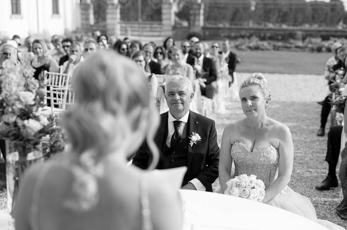 A black and white wedding photo showing a beautiful outdoor ceremony setup.