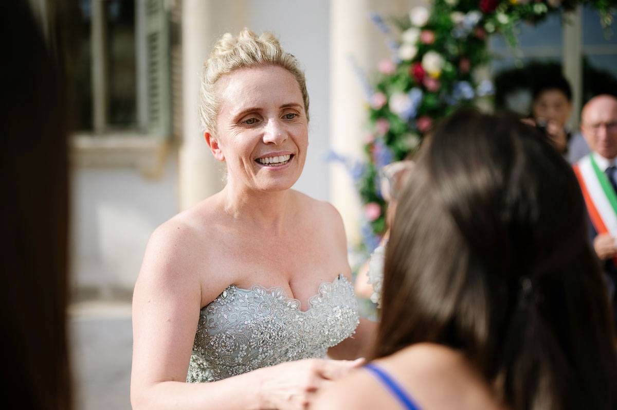 Joyful moment shared between guests during outdoor wedding celebration.