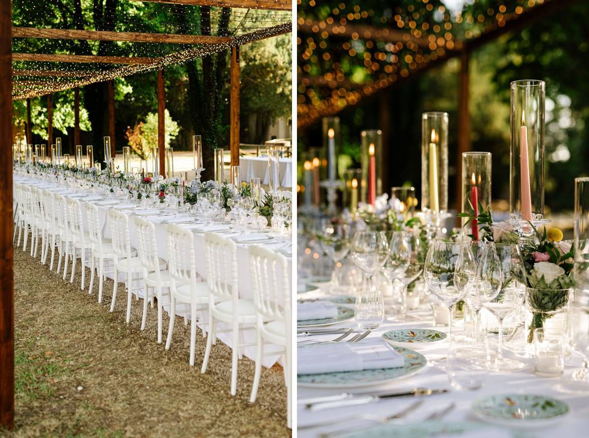 Long reception tables with white chairs and elegant place settings under twinkle lights.