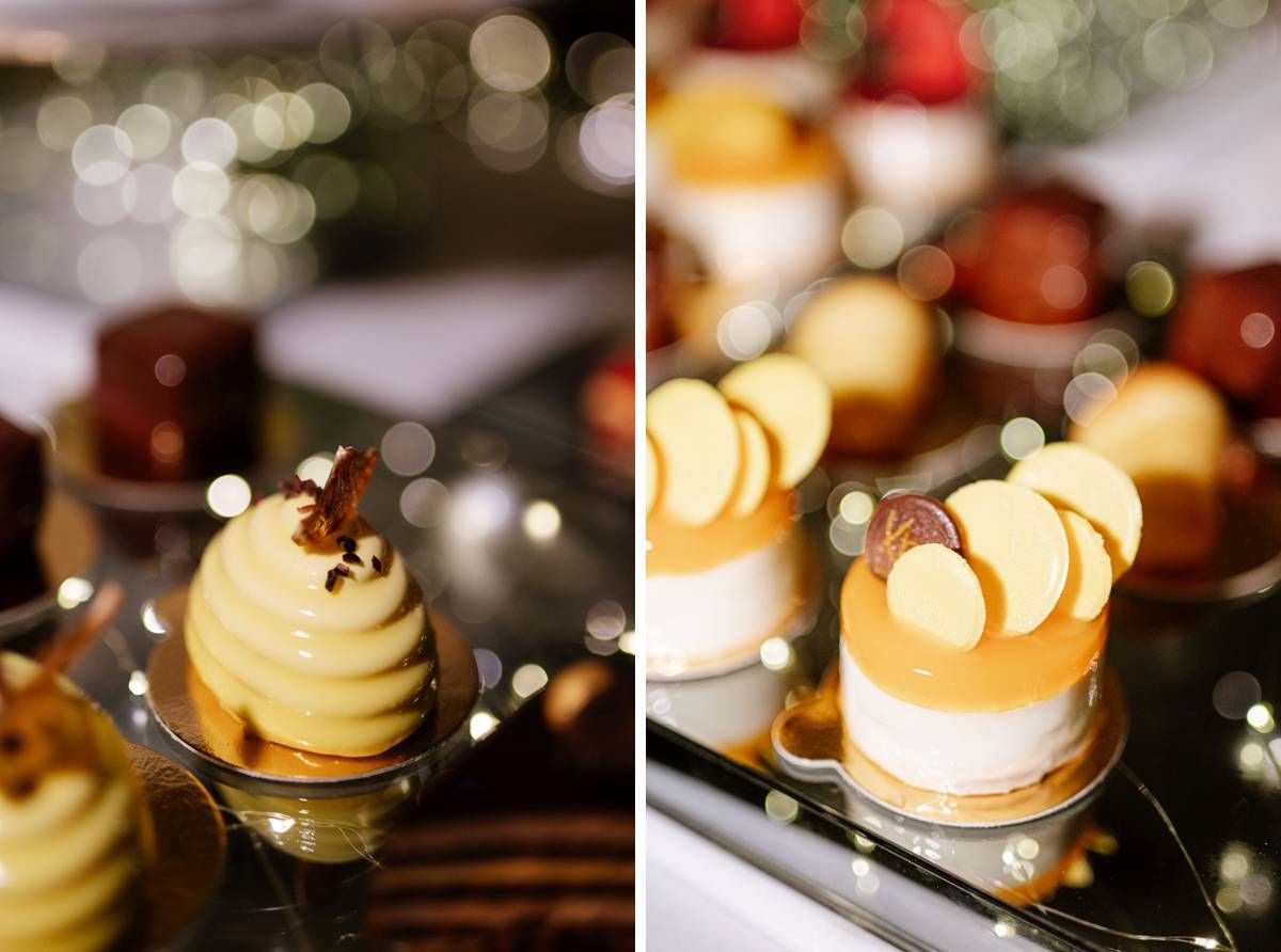 Elegant dome-shaped desserts with caramel drizzle displayed on black plates with bokeh lighting.