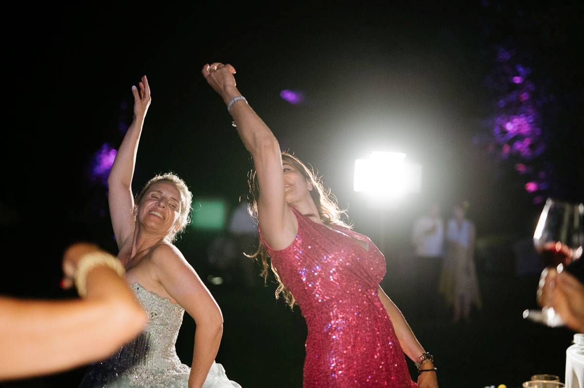 Energetic dance floor moment captured at a nighttime wedding celebration.