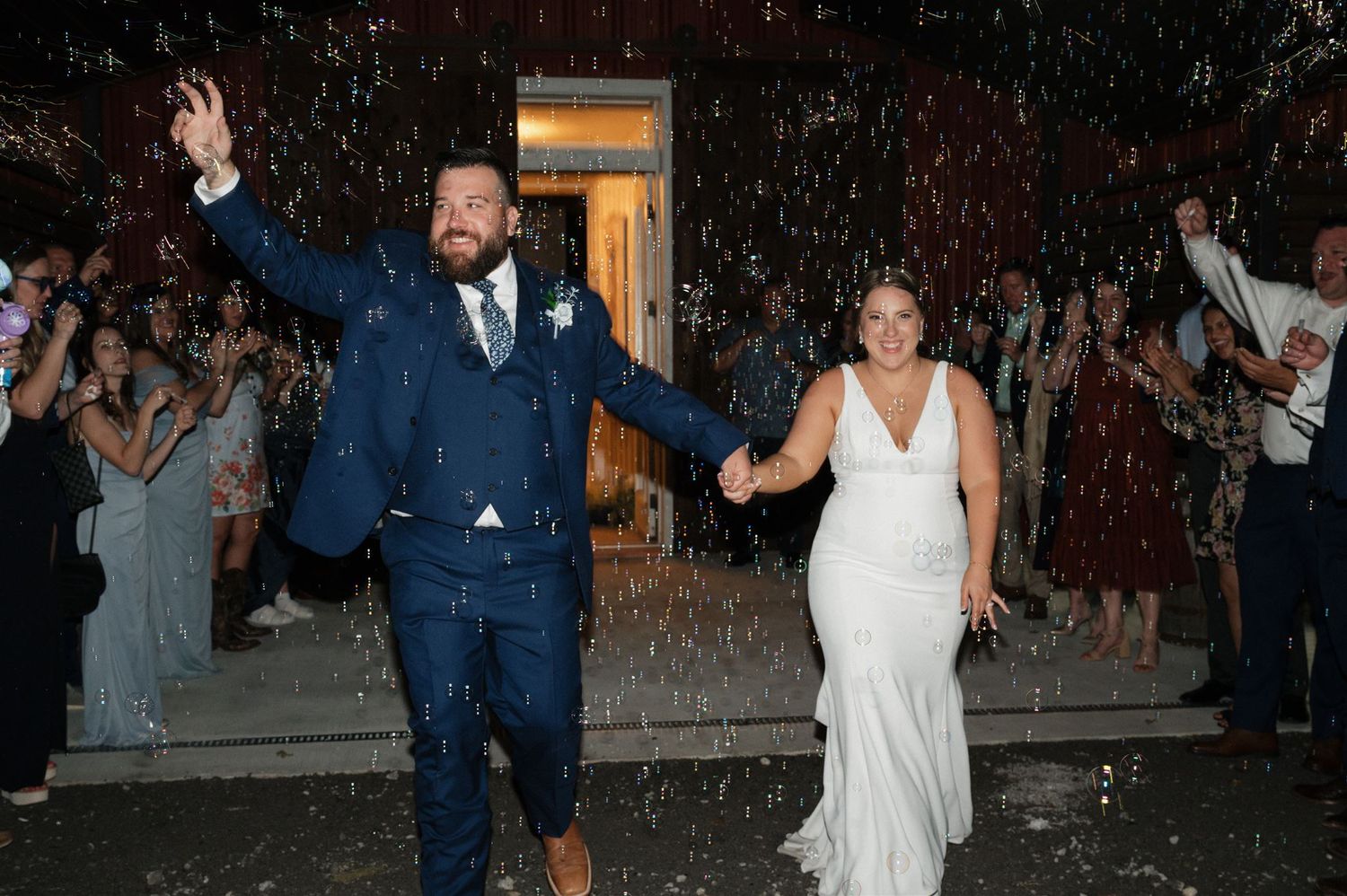 Couple celebrates during sparkler exit at their wedding reception.
