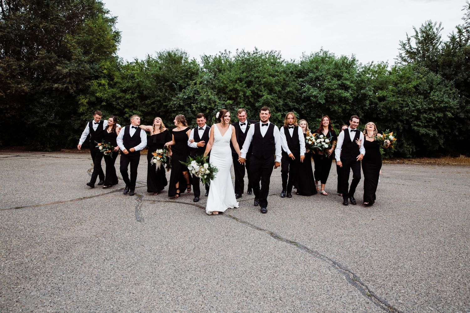 Bride and groom walking surrounded by their bridal party