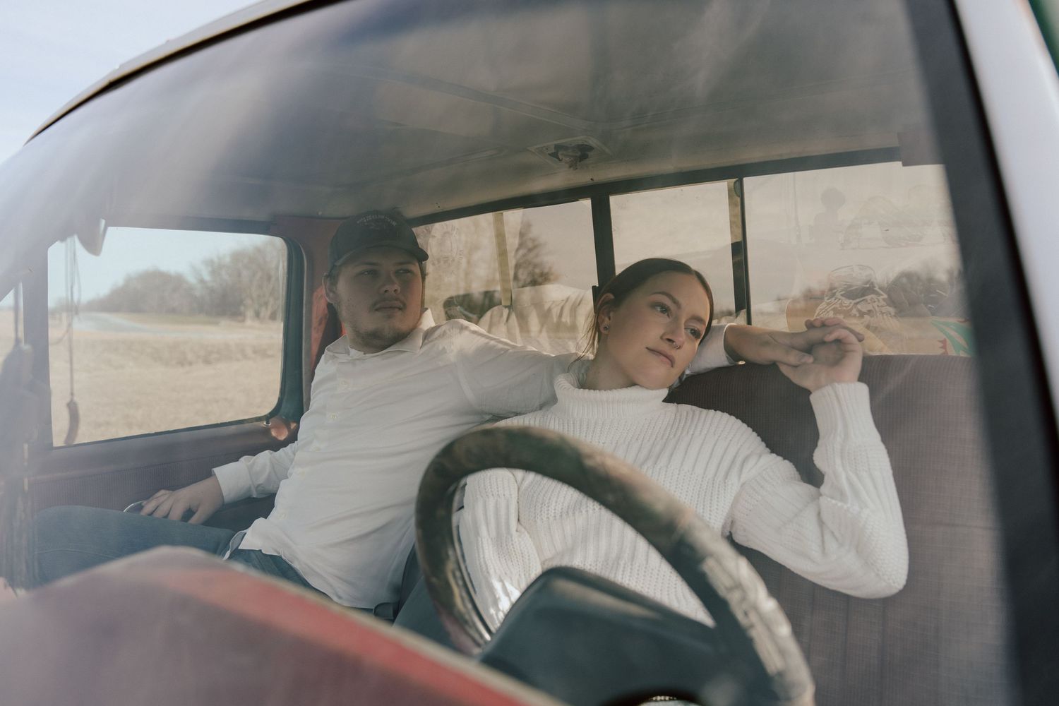 Group of friends sleeping together in a car during a road trip.