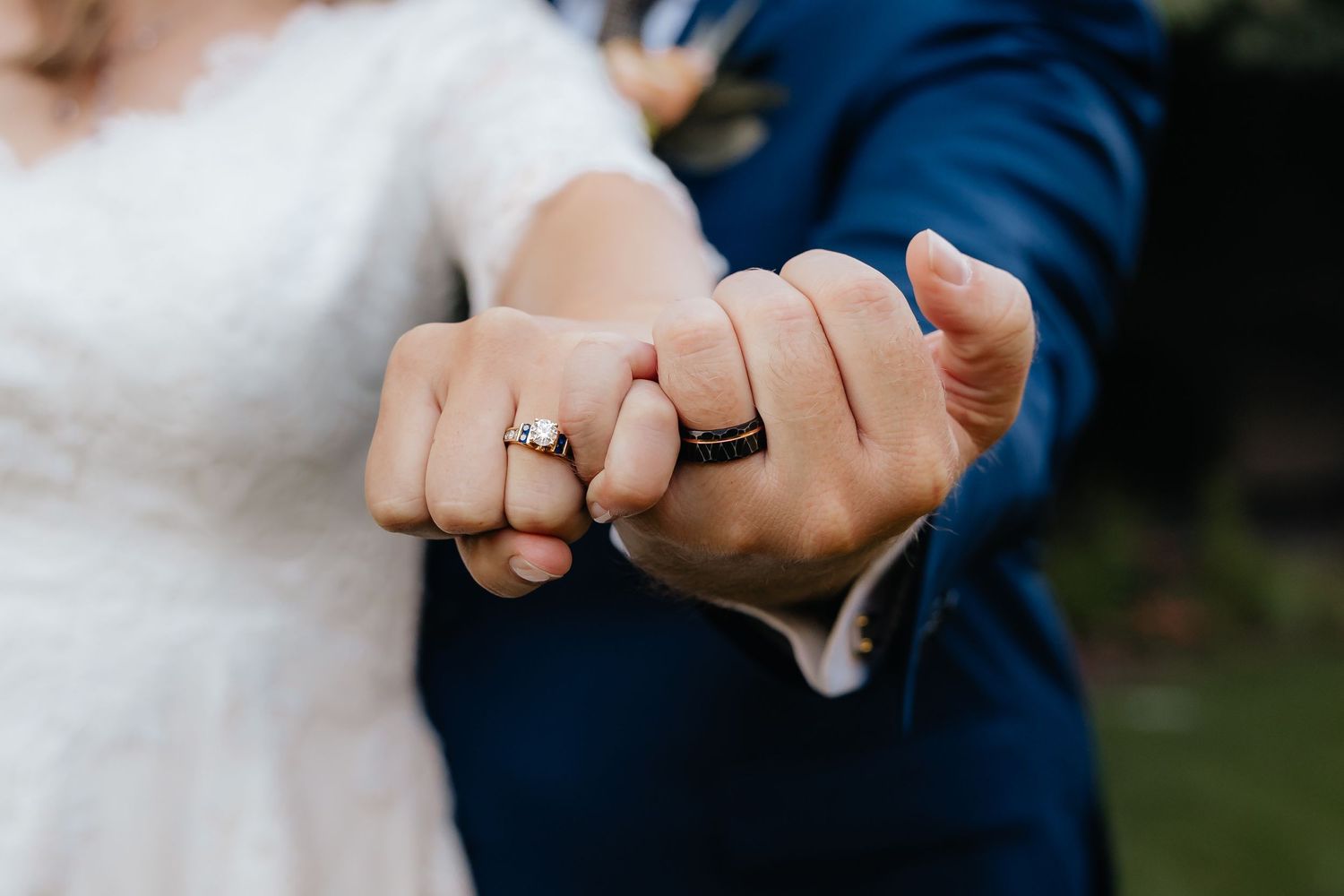 Wedding Couple pinky's twisted together to show wedding rings