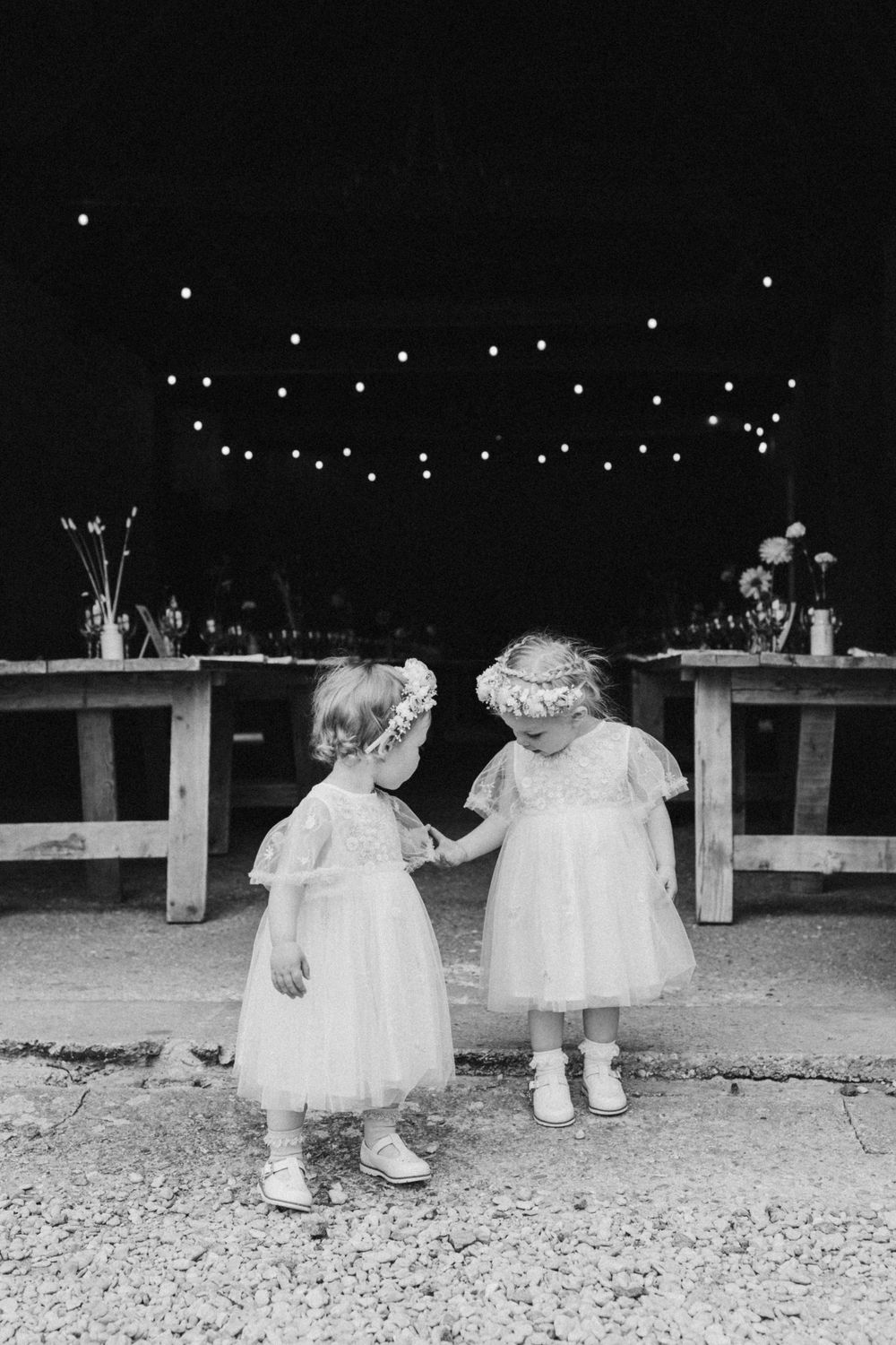 black and white photo of two adorable flower girls before the wedding ceremony