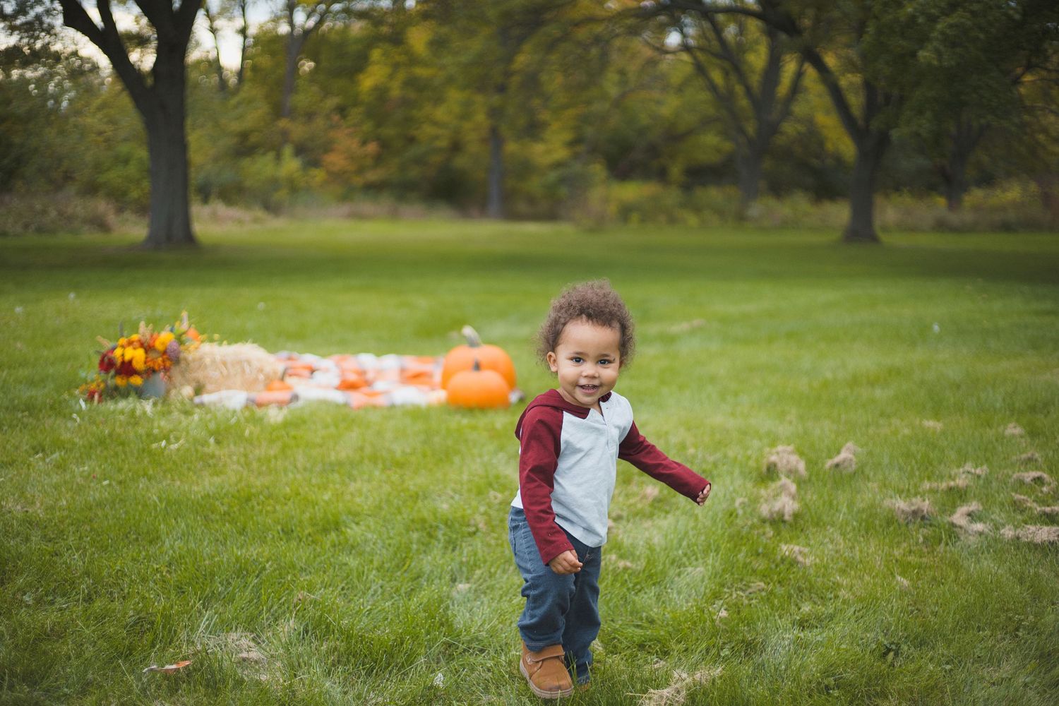 smiling toddler pumpkins fall photoshoot outdoors odana hills park