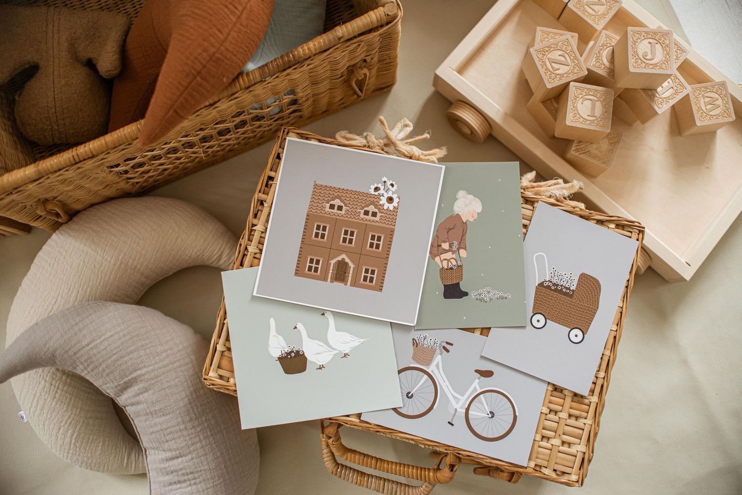 Collection of minimalist nursery cards featuring houses, bicycles and animals in neutral tones.