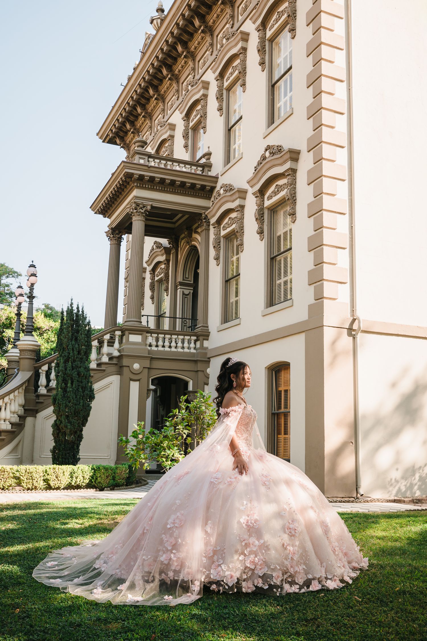 Beautiful ballgown dress photographed against an elegant historic building with classical architecture.