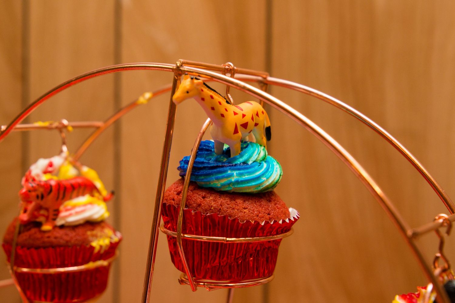Close-up of a decorative carnival Ferris wheel with brightly colored cupcake holders.