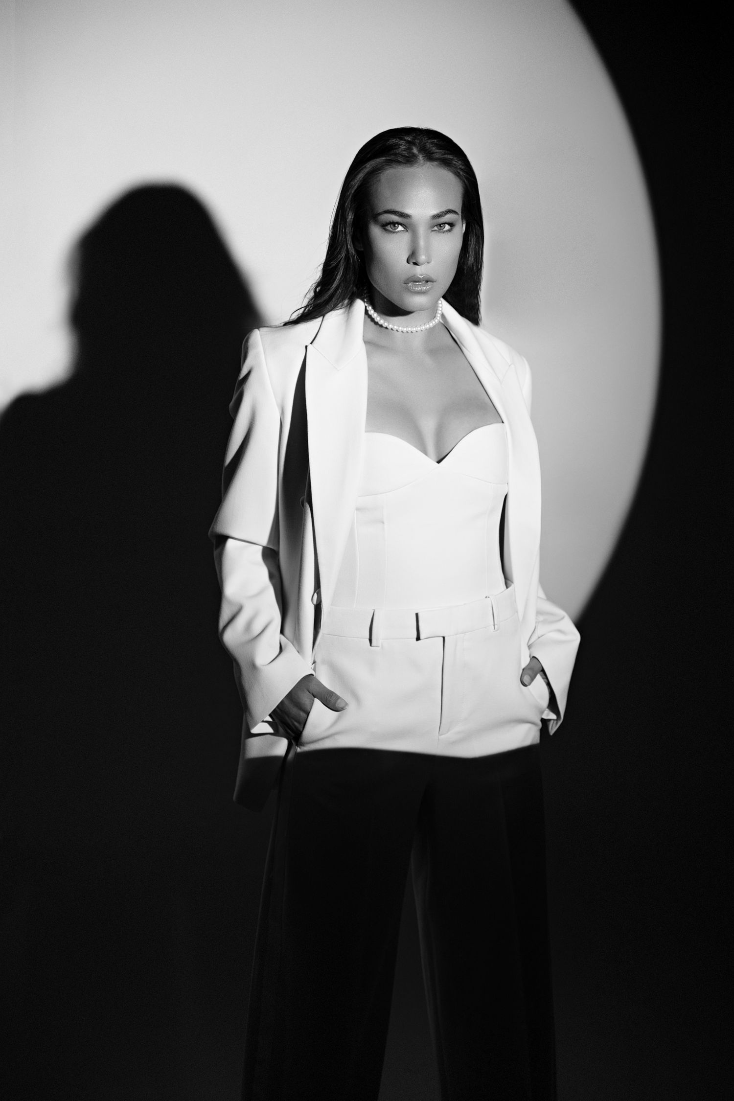 A model with dark hair in a studio with a spotlight by daryanaorange.com in San Diego.