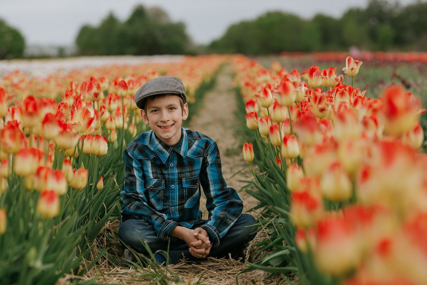 Child surrounded by vibrant tulips in a picturesque field near Ottawa, ON.