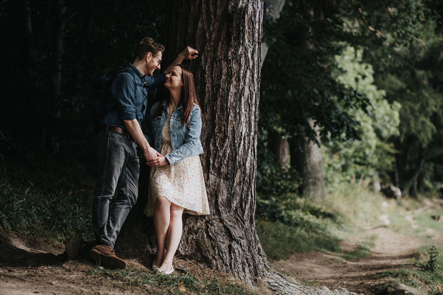 a couple standing by a tree