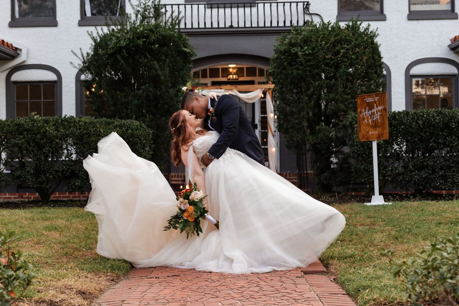 beautiful authentic wedding photo of couple in wedding attire in front of venue taken by photographer in orlando