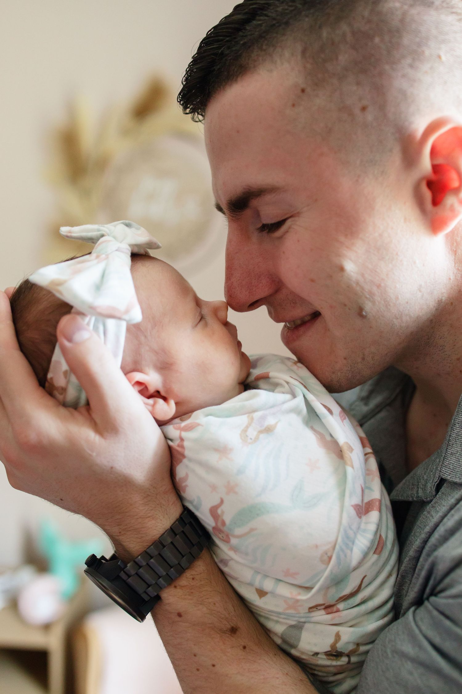 dad snuggling and holding baby close to his face