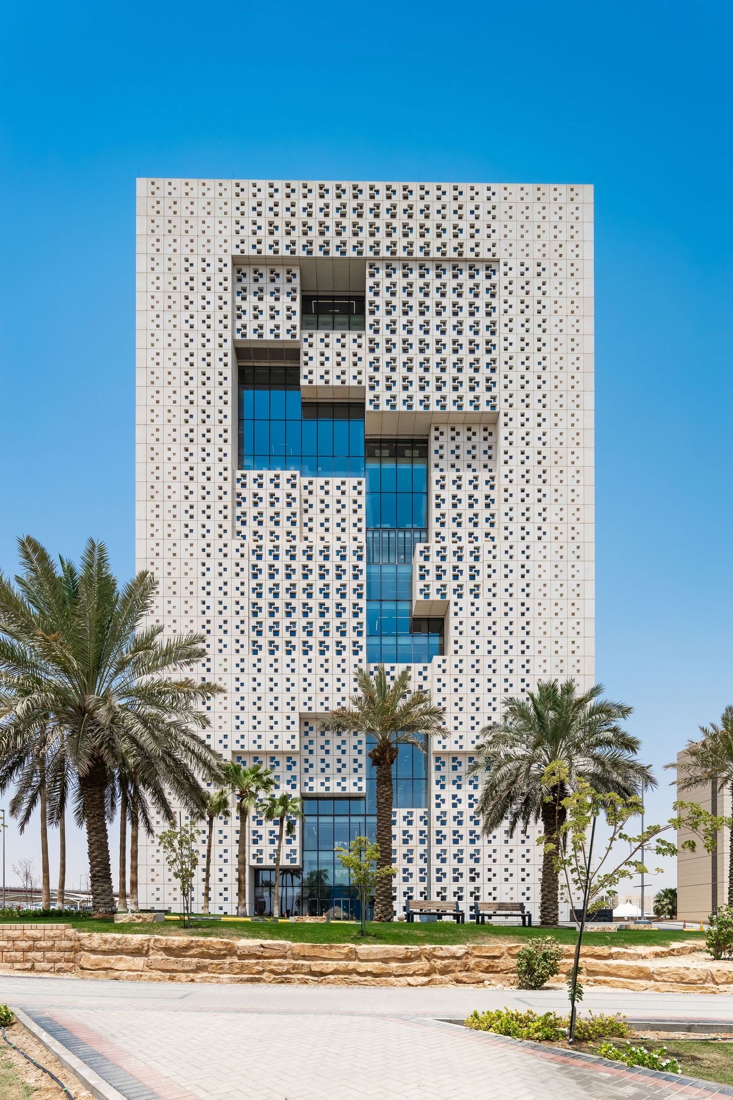 White architectural building featuring geometric patterns and blue glass windows.