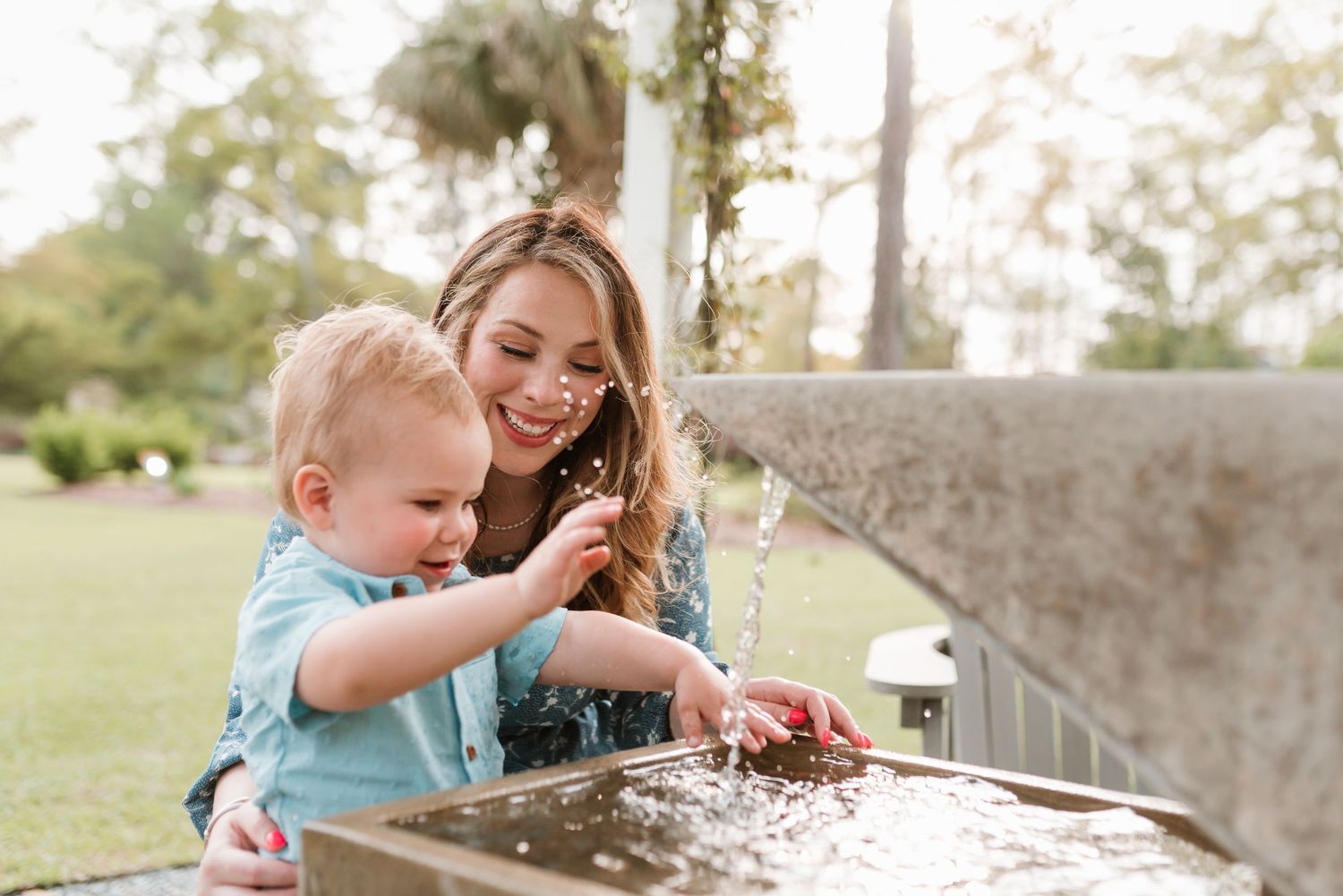 A joyful outdoor family photography session on a grassy field.