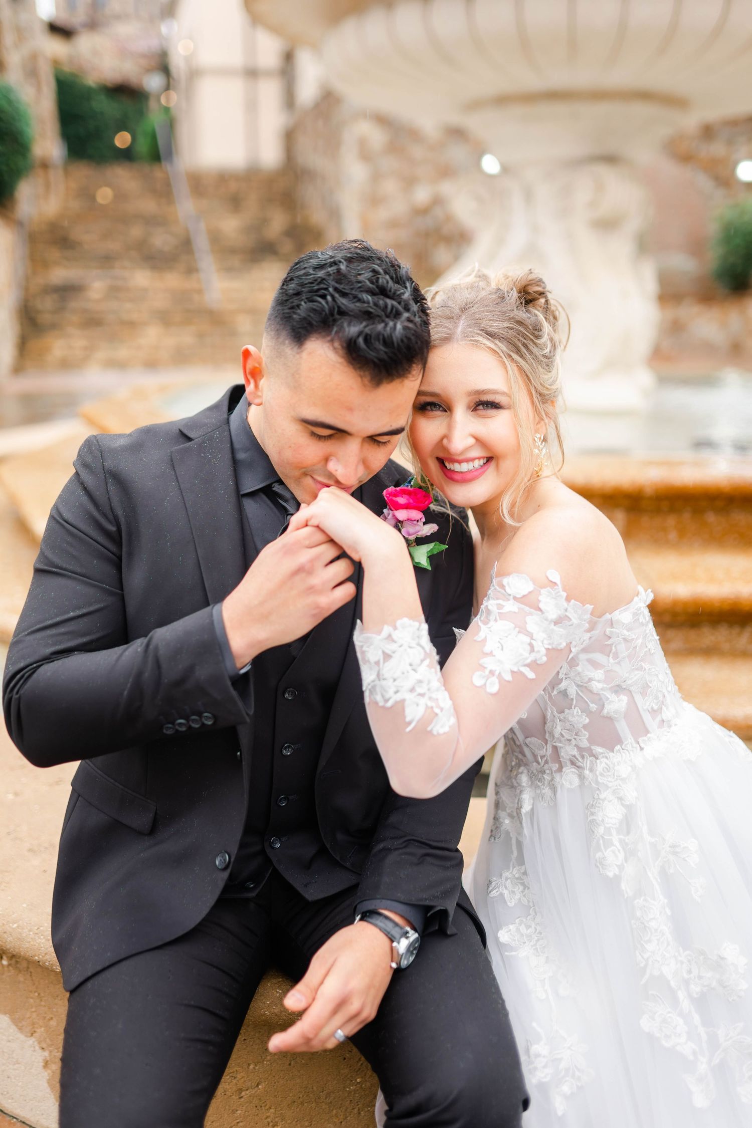 A bride and groom embrace affectionately on their wedding day.
