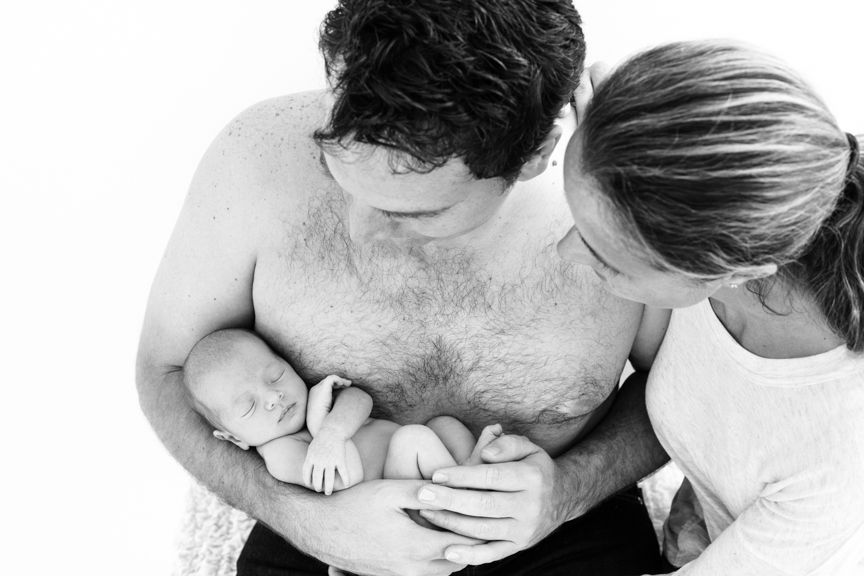 Intimate black and white photos capturing tender family moments and connections.