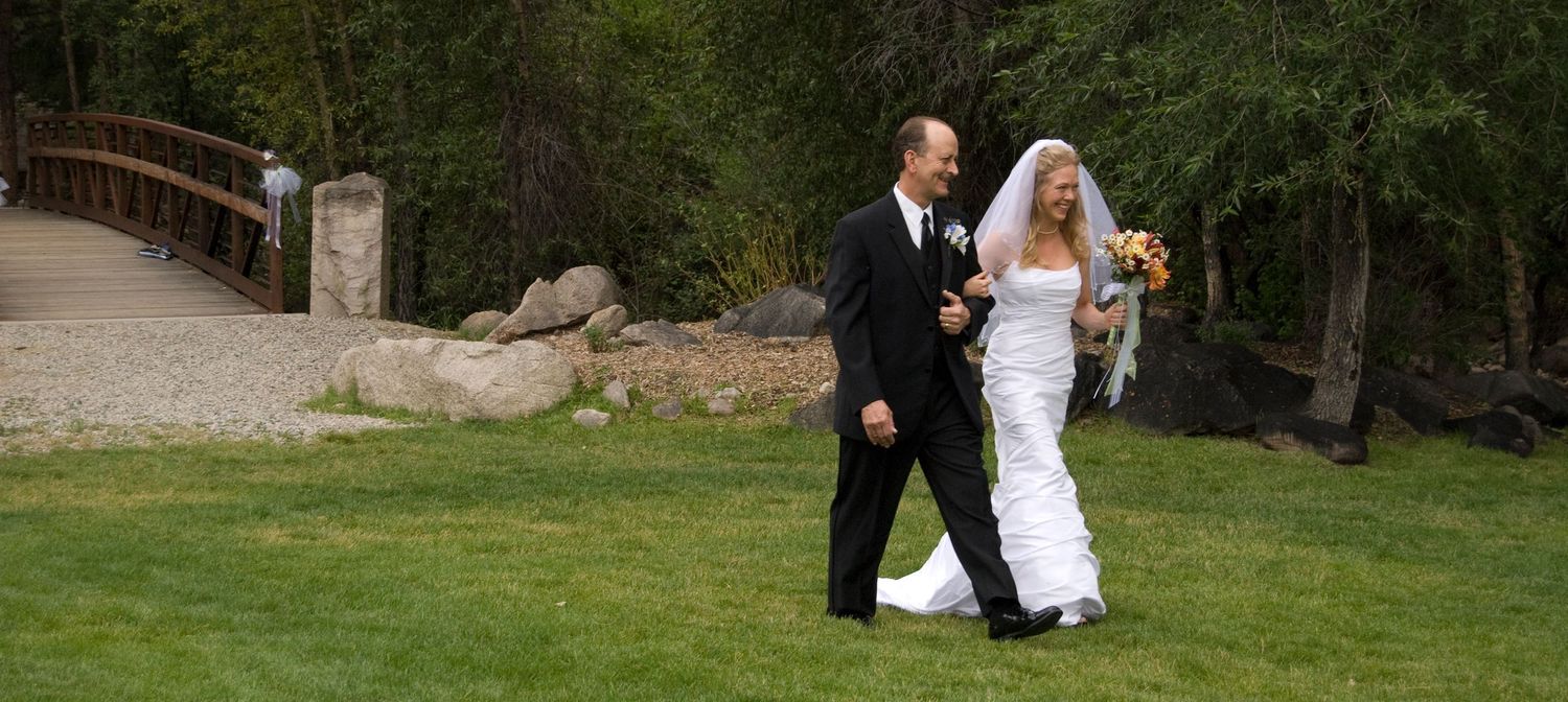 Father walks his daughter down the aisle in outdoor settings