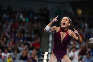 Emotional reactions and celebrations during competitive gymnastics meet.