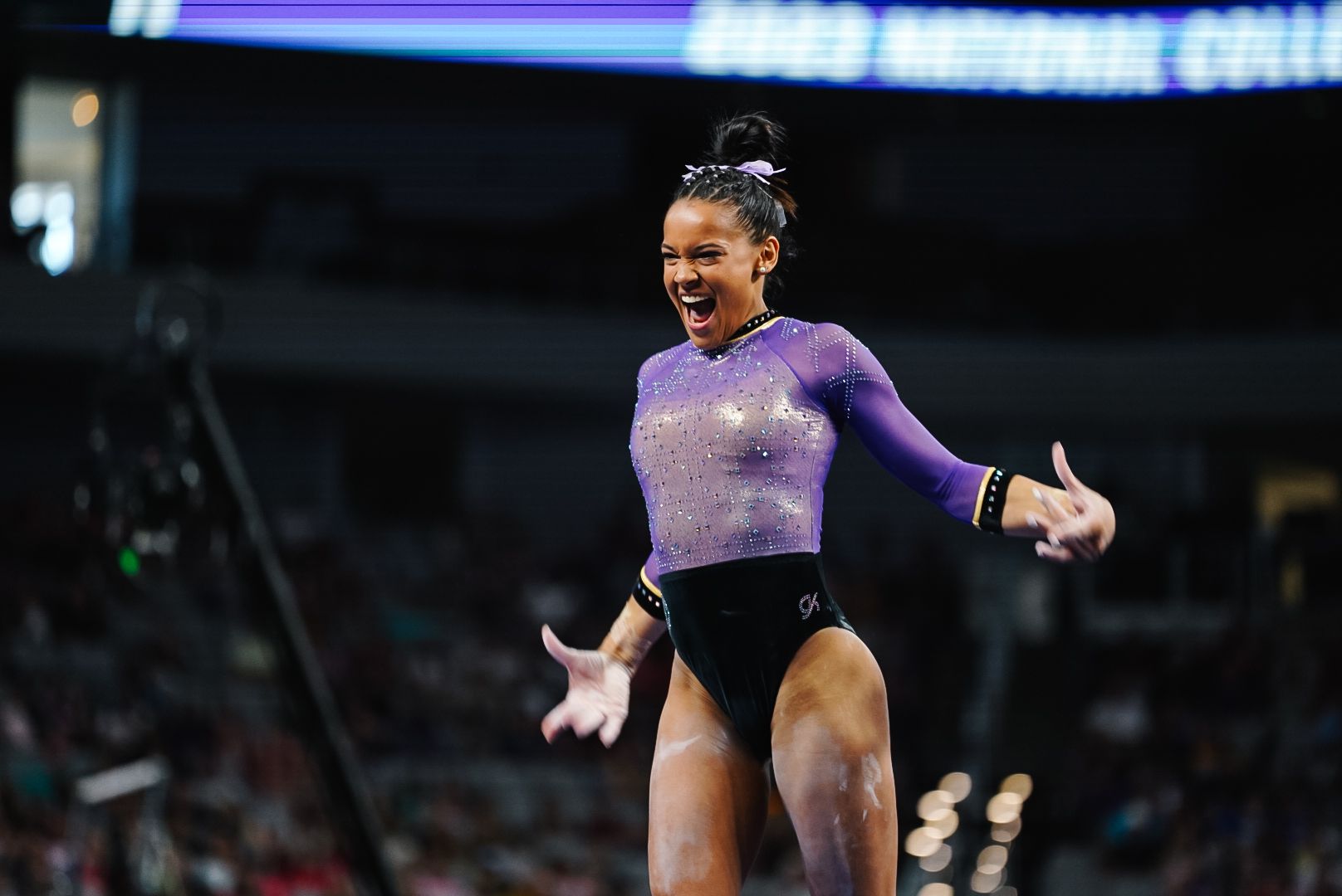 Gymnast celebrating during 2023 NCAA championship competition.