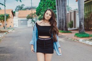 Casual street style photography with denim and black clothing against urban background.