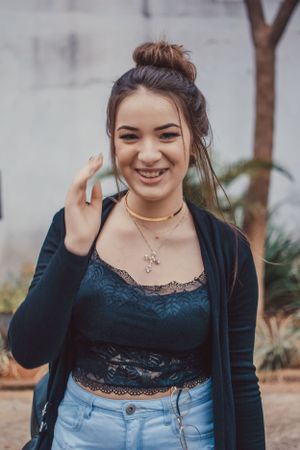 Natural outdoor portrait featuring black lace top, cardigan and delicate necklace.