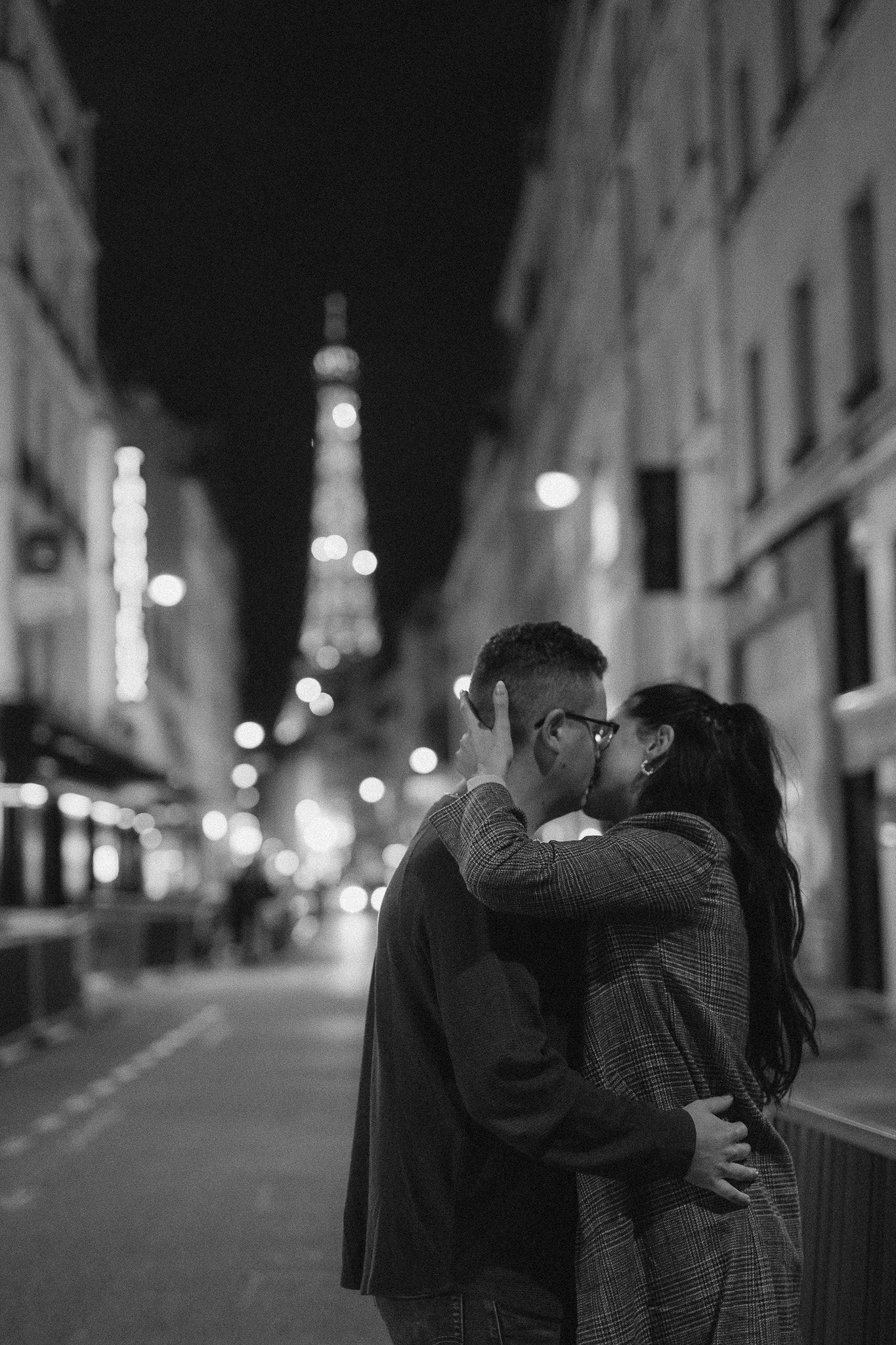 Couple portraits during their Paris proposal with the Eiffel tower twinkling in the background