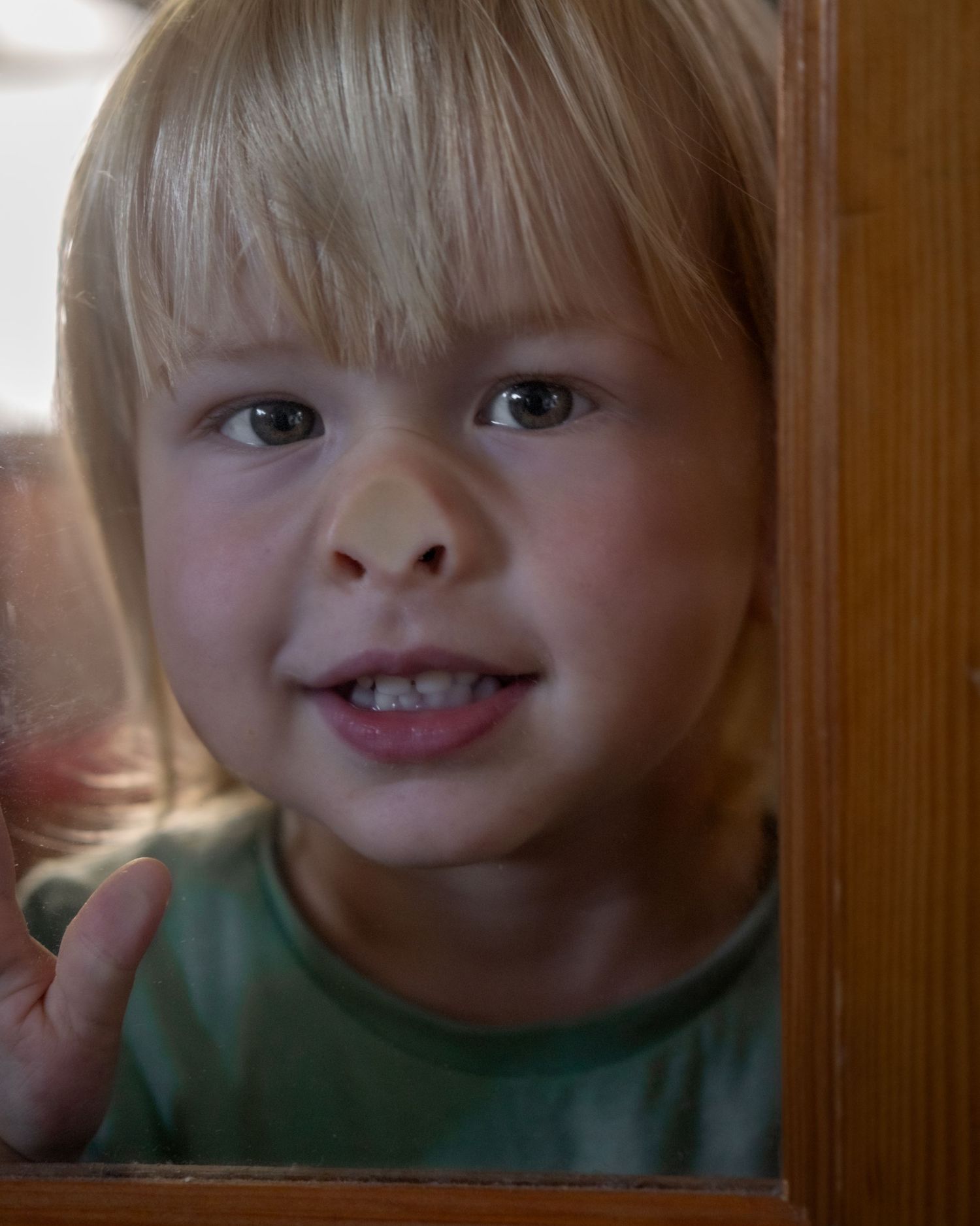 Close-up fun funny portrait of smiling young child, North Vancouver family lifestyle photographer